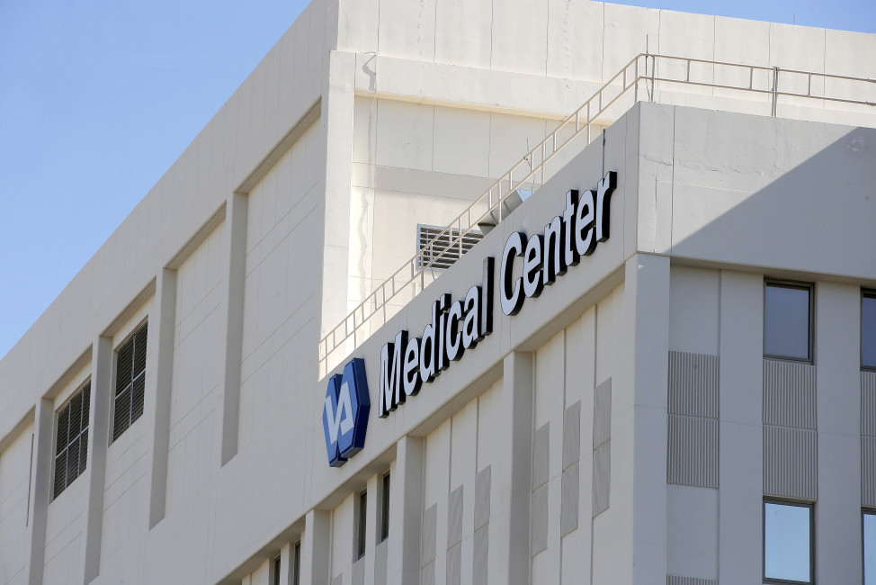 FILE-- This April 28, 2014 file photo shows the Phoenix VA Health Care Center in Phoenix.   Sharon Helman, the former director of the Phoenix VA Health Care System, is suing the Department of Veterans Affairs to win her old job back. Helman argues in court papers that a key portion of a 2014 law passed in response to the wait-time scandal is unconstitutional and denies her right to appeal her firing. Attorney General Loretta Lynch says in a letter to Congress that the Justice Department has decided not to contest that element of Helman’s challenge, essentially agreeing with her legal position. Lynch says Justice will continue fighting against Helman's reinstatement.   (AP Photo/Ross D. Franklin, File)