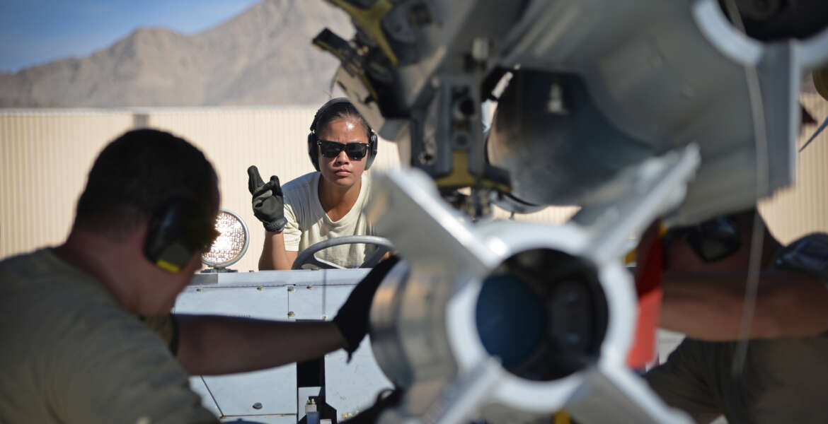 U.S. Air Force Senior Airman Jerilyn Co, armament systems specialist with the New Jersey Air National Guard's 177th Fighter Wing, works with her team to load munitions onto an F-16 Fighting Falcon during Red Flag 16-3, July 20, 2016, on Nellis Air Force Base, Nev. (U.S. Air National Guard photo by Senior Airman Shane Karp/Released)