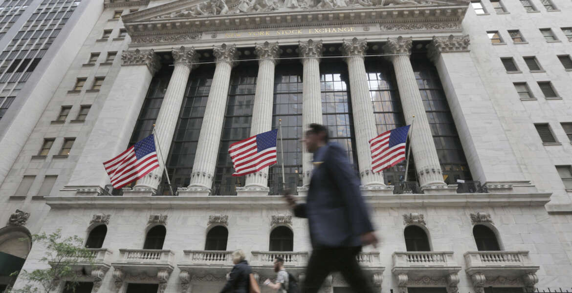 FILE - In this Friday, June 24, 2016, file photo, people walk by the New York Stock Exchange. Global stocks mostly rose Friday, July 1, as authorities stepped in to ease the uncertainty surrounding the British vote to leave the European Union. Investors flocked to equities in the face of narrowing choices for investments amid low or negative interest rates on many bonds. (AP Photo/Richard Drew, File)