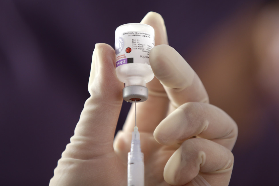 In this Monday, July 18, 2016, An Indonesian health official prepares a vaccine injection during a revaccination program for children who were earlier given fake vaccines, at a community health center in Jakarta, Indonesia. Vials of counterfeit vaccines filled with saline solution and antibiotics have been discovered at 37 hospitals and clinics in nine cities, according to the Food and Drug Agency. So far, 23 people have been arrested, including three doctors. The number of affected children is still being investigated. (AP Photo/Achmad Ibrahim)