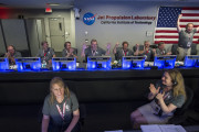 In this photo provided by NASA, Juno team members celebrate in mission control of the Space Flight Operations Facility at the Jet Propulsion Laboratory after they received confirmation from the spacecraft that it has successfully entered orbit of Jupiter, Monday, July 4, 2016, in Pasadena, Calif. The Juno mission launched August 5, 2011, and will orbit the planet for 20 months to collect data on the planetary core, map the magnetic field, and measure the amount of water and ammonia in the atmosphere.  (Aubrey Gemignani/NASA via AP)