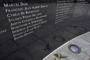 FILE - In this July 16, 2013, file photo, a lone carnation lies at the foot of the memorial that lists the names of the crew and passengers of TWA Flight 800, at Smith Point County Park in Shirley, N.Y., near where the Boeing 747 crashed in the Atlantic Ocean off the waters of the park on July 17, 1996, killing all 230 people on board. Twenty years after the aircraft exploded in a fireball off Long Island, the passage of time has been a salve for some, but others will never get over the heartache. (AP Photo/Kathy Kmonicek, File)