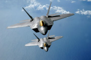 March 9, 2009 - Two F-22 Raptors fly over the Pacific Ocean during a theater security mission as part of a deployment to Andersen Air Force Base, Guam.