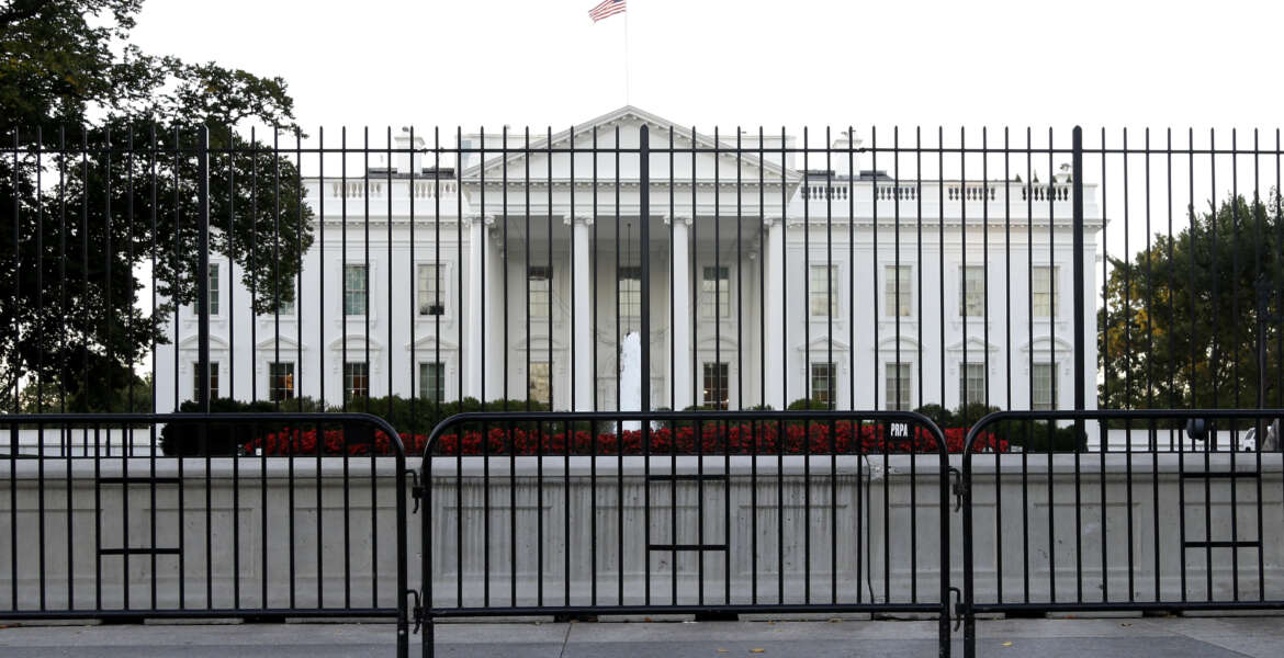 FILE - In this Sept. 22, 2014, file photo. the perimeter fence sits in front of the White House fence on the North Lawn along Pennsylvania Avenue in Washington. Most young Americans say the Republican and Democratic parties don’t represent them, a critical data point after a year of ferocious presidential primaries that forced partisans on both sides to confront what _ and whom _ they stand for. A new GenForward poll also shows that disconnect holds true across racial and ethnic groups, with just 28 percent of young adults overall saying two parties do a good job of representing the American people. (AP Photo/Carolyn Kaster, File)