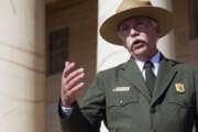 FILE - In this July 17, 2014 file photo, National Park Service Director Jonathan Jarvis speaks during a news conference at the historical Arlington House at Arlington National Cemetery in Arlington, Va. In an interview with The Associated Press on Friday, Aug. 22, 2014, Jarvis said he plans to recommend that the Interior Secretary ask President Obama to declare Chicagos historic Pullman neighborhood a unit of the national park system. The neighborhoods ornate brick homes were built in the 1800s by industrialist George Pullman as a blue-collar utopia to house workers from his sleeping-railcar factory. Supporters say the neighborhood also is significant for its place in revolutionizing the railroad industry and its contributions to the African-American labor movement. (AP Photo/Cliff Owen, File)