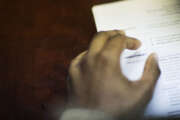 FILE - In this Thursday, March 3, 2016, file photo, a job candidate's resume sits on a table as he interviews for a job with a restaurant during a recruiting event at the Georgia Department of Labor office, in Atlanta. The Labor Department reports Thursday, Aug. 4, 2016, on the number of Americans applying for unemployment benefits a week earlier. (AP Photo/David Goldman, File)