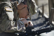 In this photo taken Wednesday, Aug. 17, 2016 U.S. Army Pvt. Austin Lewis adjusts his M-4 weapon's sights while participating in marksmanship training at Fort Jackson, S.C. While some of the Army's newest recruits may have grown up using rifles to hunt or take target practice, the drill sergeants charged with turning 45,000 civilians into warriors every year say more than half may have never touched a gun. (AP Photo/Gerry Broome)