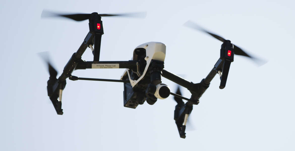 FILE - In this April 14, 2016 file photo, a drone captures videos and still images of an apartment building in Philadelphia. Federal aviation officials say so many people are registering drones and applying for drone pilot licenses, they wonder if there will eventually be millions of drones crowding the nation's skies.  (AP Photo/Matt Rourke, File)