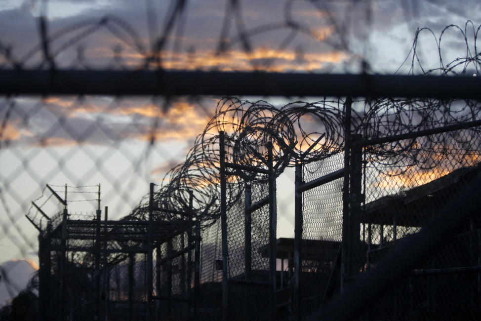 FILE - In this Nov. 21, 2013 file photo reviewed by the U.S. military, dawn arrives at the now closed Camp X-Ray, which was used as the first detention facility for al-Qaida and Taliban militants who were captured after the Sept. 11 attacks, at the Guantanamo Bay Naval Base, Cuba. A recently released transcript from the U.S. base at Guantanamo Bay, Cuba, features new allegations of involvement in terrorism by officials in Saudi Arabia, including an unnamed member of the royal family.  (AP Photo/Charles Dharapak, File)