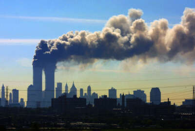FILE - In this Sept. 11, 2001 file photo, as seen from the New Jersey Turnpike near Kearny, N.J., smoke billows from the twin towers of the World Trade Center in New York after airplanes crashed into both towers. Saudi Arabia and its allies are warning that legislation allowing the kingdom to be sued for the 9/11 attacks will have negative repercussions. The kingdom maintains an arsenal of tools to retaliate with, including curtailing official contacts, pulling billions of dollars from the U.S. economy, and enlisting its lockstep Gulf allies to scale back counterterrorism cooperation, investments and U.S. access to important regional air bases. (AP Photo/Gene Boyars, File)
