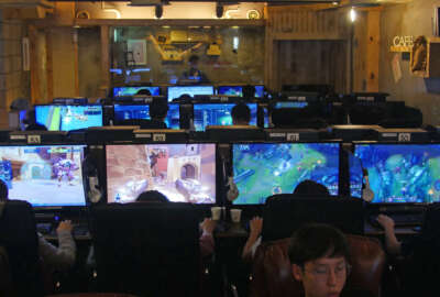 In this Aug. 30, 2016 photo, people play computer games at a PC cafe in Seoul, South Korea. South Korea has the biggest e-Sports industry in the world with professional leagues and broadcasting channels. South Korea started the e-sports industry in the early 2000s, and it continues to be a world leader in competitive gaming. There are not only professional video game players, but also broadcasting channels and professional leagues for different kinds of games. South Koreans can easily watch professional gamers playing on both television and the internet. (AP Photo/Jungho Choi)
