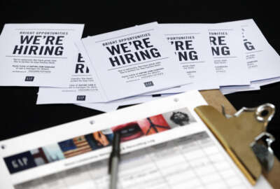 FILE - In this Tuesday, Oct. 6, 2015, file photo, job applications and information for the Gap Factory Store sit on a table during a job fair at Dolphin Mall in Miami.  Fewer Americans applied for unemployment benefits last week of Aug. 2016, another sign the U.S. job market remains healthy despite a downshift in hiring in August. The Labor Department says the number of applications for jobless aid slid by 4,000 last week to a seasonally adjusted 259,000, lowest since mid-July. (AP Photo/Wilfredo Lee, File)