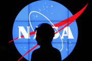 South Korean President Park Geun-hye walks past a NASA logo during a tour of projects and programs that are underway at the agency's Goddard Space Flight Center, Wednesday, Oct. 14, 2015, in Greenbelt, Md. (AP Photo/Patrick Semansky)