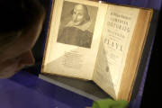 FILE - This is a  Tuesday, Oct. 11, 2016  file photo of book conservator Lauren Schott polishes a case containing 17th century editions of plays attributed to William Shakespeare in an exhibit called "Shakespeare Unauthorized" at the Boston Public Library, in Boston, Mass.  Oxford University Press’ new edition of William Shakespeare’s works will credit Christopher Marlowe as co-author of the three Henry VI plays, underscoring that the playwright collaborated with others on some of his most famous works. (AP Photo/Steven Senne, File)