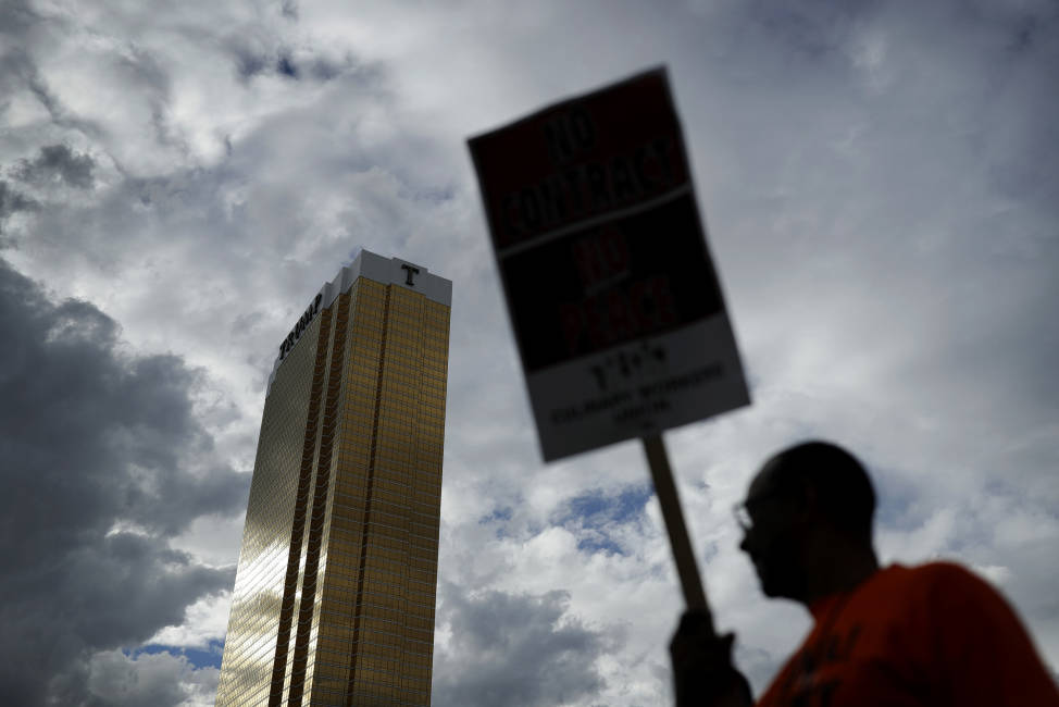 FILE - In this Sept. 21, 2016 file photo Laborers' International Union of North America members and Culinary Union members protest outside of the Trump International hotel in Las Vegas. Inflamed by Trump's candidacy, organized labor groups including the heavily immigrant Culinary Union are in the thick of an aggressive get-out-the-vote campaign in Nevada. The election comes just as the Culinary Union engages in a labor dispute with management at Trump's Las Vegas hotel, adding more ammunition to their campaign against him. (AP Photo/John Locher, File)