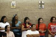 In this photo taken Wednesday, July 13, 2016 members of the Hispanic community gather during a Faith Action ID drive at Holy Family Catholic Church in Hillsborough, N.C. More than 200 people with no legal U.S. identification gathered to learn how to use their new $10 ID cards to communicate with police. (AP Photo/Gerry Broome)