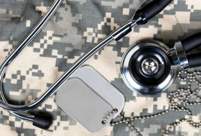 Military uniform with stethoscope and identification tags. Overhead view in horizontal layout.