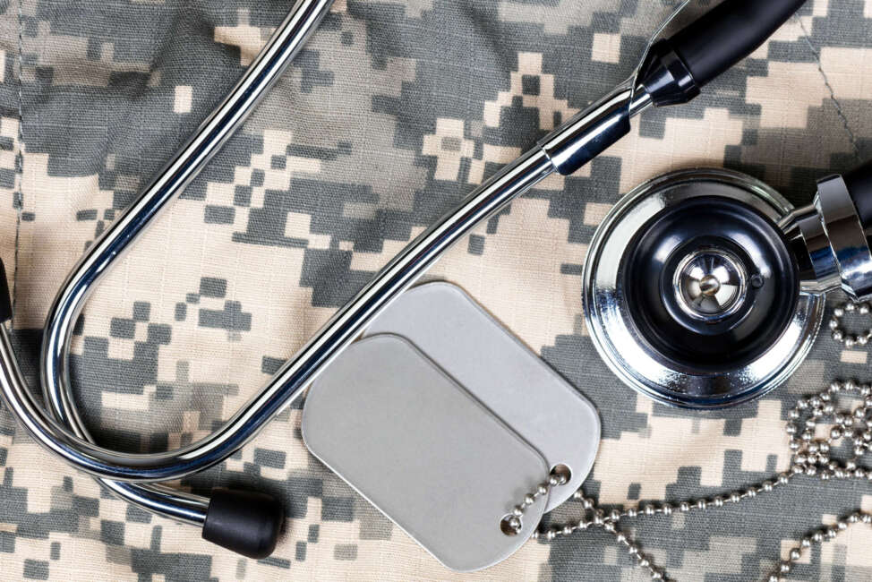 Military uniform with stethoscope and identification tags. Overhead view in horizontal layout.