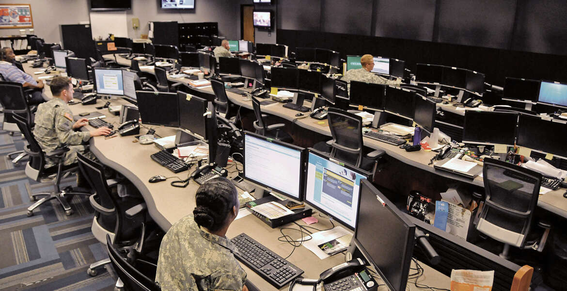 Uniformed and civilian cyber and military intelligence specialists monitor Army networks in the Cyber Mission Unit’s Cyber Operations Center at Fort Gordon, Ga.