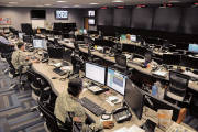 Uniformed and civilian cyber and military intelligence specialists monitor Army networks in the Cyber Mission Unit’s Cyber Operations Center at Fort Gordon, Ga.