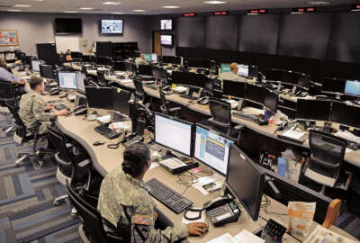 Uniformed and civilian cyber and military intelligence specialists monitor Army networks in the Cyber Mission Unit’s Cyber Operations Center at Fort Gordon, Ga.