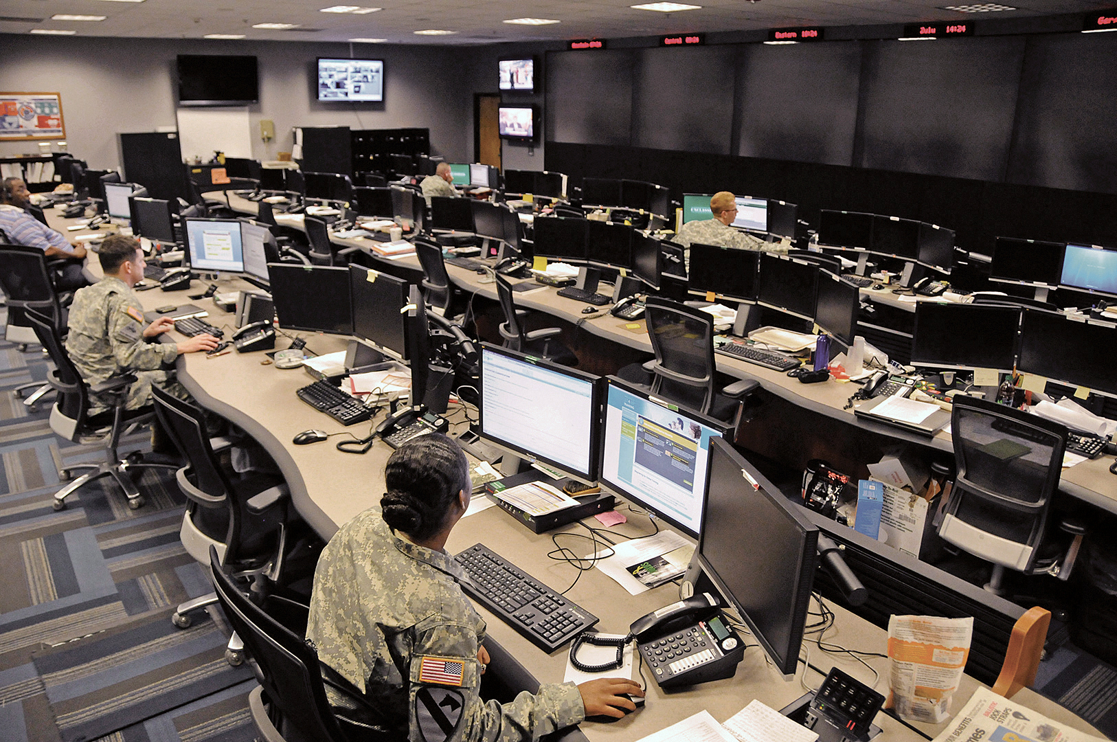 Uniformed and civilian cyber and military intelligence specialists monitor Army networks in the Cyber Mission Unit’s Cyber Operations Center at Fort Gordon, Georgia