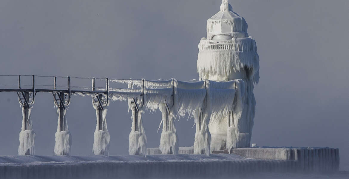 Extreme cold conditions cause ice accretions to cover the St. Joseph lighthouse and pier, on the southeastern shoreline of Lake Michigan, on Monday, Dec. 19, 2016, in St. Joseph, Mich. (Robert Franklin/South Bend Tribune via AP)