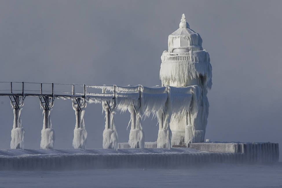 Extreme cold conditions cause ice accretions to cover the St. Joseph lighthouse and pier, on the southeastern shoreline of Lake Michigan, on Monday, Dec. 19, 2016, in St. Joseph, Mich. (Robert Franklin/South Bend Tribune via AP)