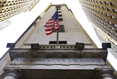 FILE - In this Friday, Nov. 13, 2015, file photo, the American flag flies above the Wall Street entrance to the New York Stock Exchange. More gains in Goldman Sachs and Chevron helped pull the Dow Jones industrial average to another record high even as other indexes were flat to lower in early trading Thursday, Dec. 1, 2016.  (AP Photo/Richard Drew, File)