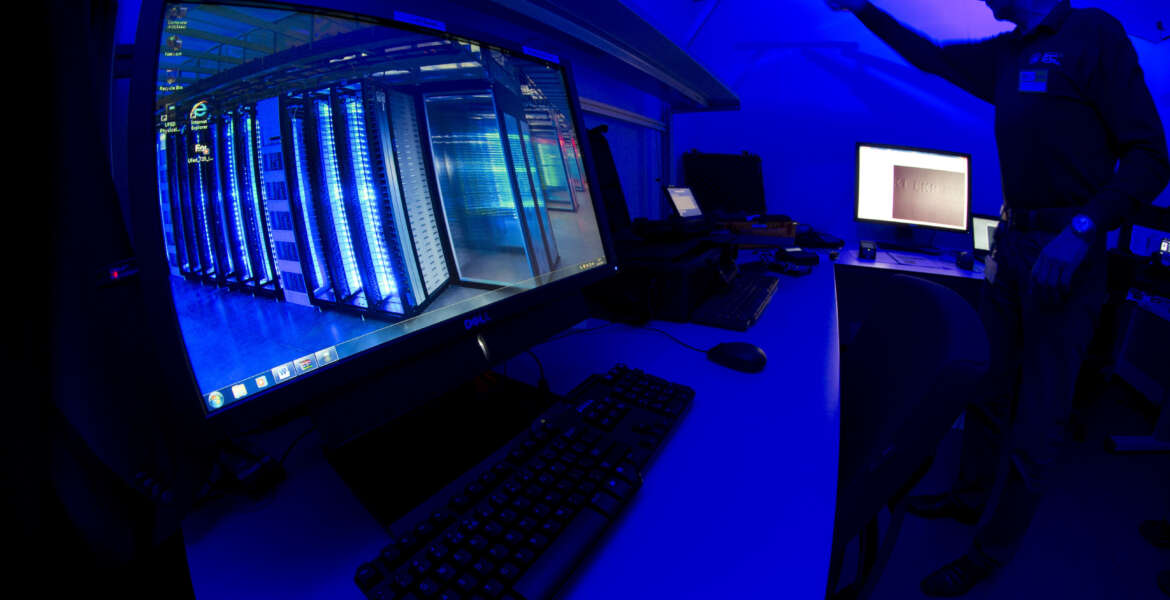 FILE - This is a Friday Jan. 11, 2013 file photo of a member of the Cybercrime Center as he turns on the light in a lab during a media tour at the occasion of the official opening of the Cybercrime Center at Europol headquarters in The Hague, Netherlands. Europol said Thursday Dec. 1, 2016, that five arrests have been made in connection with a massive operation aimed at knocking out a cybercrime group accused of inflicting hundreds of millions of euros in losses worldwide.   (AP Photo/Peter Dejong, File)