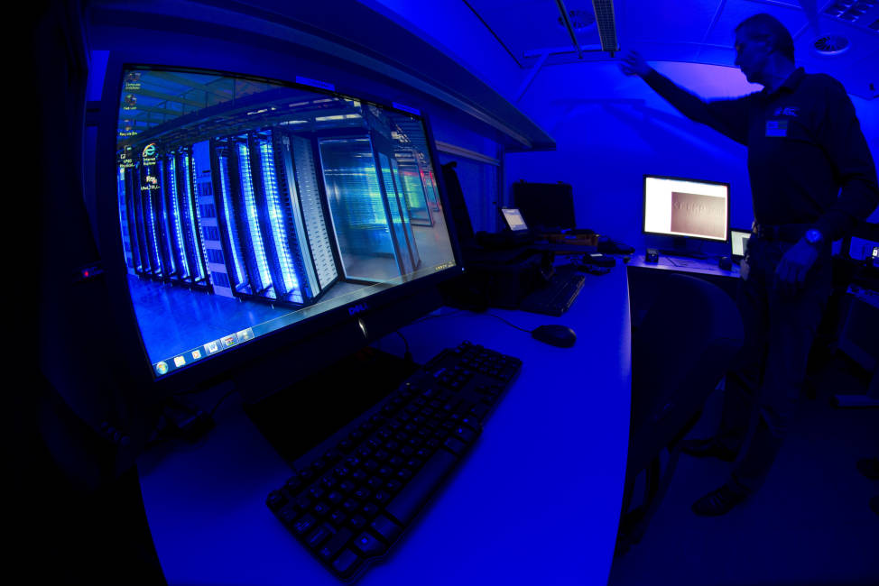 FILE - This is a Friday Jan. 11, 2013 file photo of a member of the Cybercrime Center as he turns on the light in a lab during a media tour at the occasion of the official opening of the Cybercrime Center at Europol headquarters in The Hague, Netherlands. Europol said Thursday Dec. 1, 2016, that five arrests have been made in connection with a massive operation aimed at knocking out a cybercrime group accused of inflicting hundreds of millions of euros in losses worldwide.   (AP Photo/Peter Dejong, File)