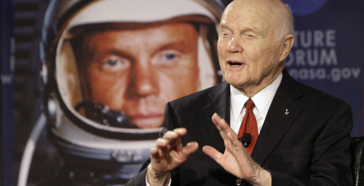 FILE - In this Feb. 20, 2012, file photo, U.S. Sen. John Glenn talks with astronauts on the International Space Station via satellite before a discussion titled 