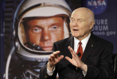FILE - In this Feb. 20, 2012, file photo, U.S. Sen. John Glenn talks with astronauts on the International Space Station via satellite before a discussion titled 