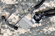 Military uniform with stethoscope and identification tags. Overhead view in horizontal layout.