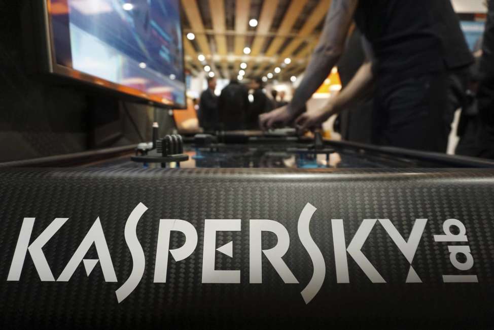 A Kaspersky employee shuffles tokens around a table-top display at the company's stand at a cybersecurity conference in Lille, northern France, Wednesday, Jan. 25, 2017. Kaspersky on Wednesday confirmed that a senior manager at the firm had been arrested in Moscow. (AP Photo/Raphael Satter)