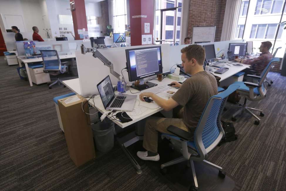 FILE- This Sept. 19, 2013, file photo shows workers at the Target Technology Innovation Center office in San Francisco.  The job market has changed under President Barack Obama's 8 years.  Young people are flooding in as the elderly retire.   (AP Photo/Jeff Chiu, File)