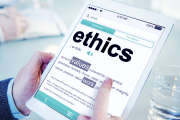 Man Reading the Definition of Ethics