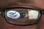 FILE - In this Sept. 30, 2011, file photo, a reflection of the Department of Homeland Security logo is seen reflected in the glasses of a cyber security analyst in the watch and warning center at the Department of Homeland Security's secretive cyber defense facility at Idaho National Laboratory in Idaho Falls, Idaho. Through history, the United States has relied on its borders and superior military might to protect against and deter foreign aggressors. But a lack of boundaries and any rulebook in cyberspace has increased the threat and leveled the playing field today. (AP Photo/Mark J. Terrill, File)