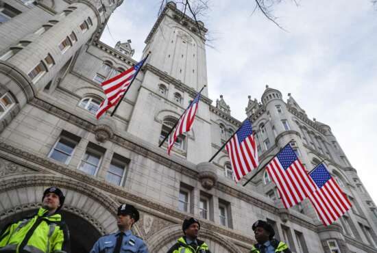 In this Jan. 19, 2017, photo, police stand guard outside the Trump International Hotel on Pennsylvania Avenue in Washington. While President Donald Trump’s hotel in Washington did serve as a hub of inaugural activities it also stands as ground zero for what top Democrats and some ethics advisers see as his unique web of conflicts of interest. Trump’s lease with the federal government to develop and operate a hotel inside the historic Old Post Office building expressly prohibits any elected official from benefiting from the property, yet Trump has not divested from his company or this particular project. (AP Photo/John Minchillo)