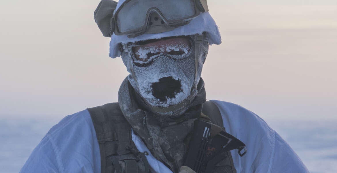 1st Sgt. Erik Carlson, Headquarters Troop, 1st Squadron, 40th Cavalry, 4th Infantry Brigade Combat Team (Airborne), 25th Infantry Division awaits transportation at an extraction point after a successful airborne operation in Deadhorse, Alaska, February 22. The battalion's Arctic capabilities were tested as temperatures with wind chill reached as low as 63 below zero. (U.S. Army photo by Staff Sgt. Daniel Love)