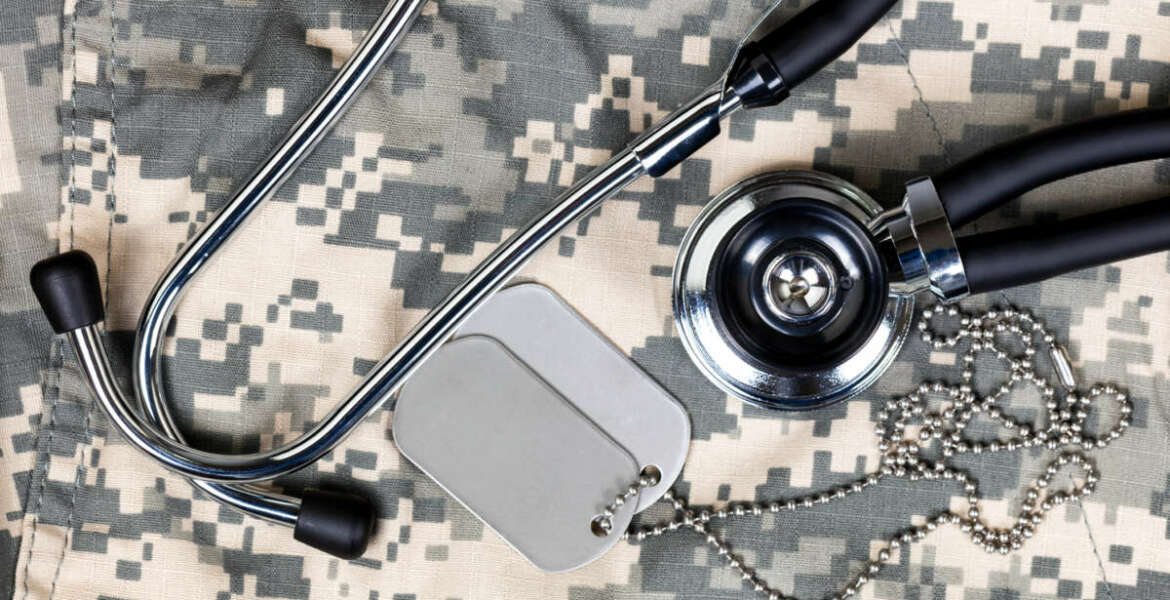 Military uniform with stethoscope and identification tags. Overhead view in horizontal layout.