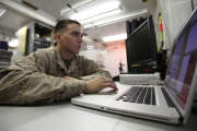 U.S. Marine Corps Lance Cpl. Zachary Oullette, a combat videographer with 2nd Marine Division (Forward) Combat Camera (COMCAM), edits a video production on a laptop computer inside of the tactical imagery production system (TIPS) multimedia van at Camp Leatherneck in Helmand province, Afghanistan, May 25, 2011. The TIPS was used by COMCAM to produce graphic, photo, video and printed products for units in the area while deployed in support of Operation Enduring Freedom. (U.S. Marine Corps photo by Chief Warrant Officer 2 Clinton W. Runyon/Released)