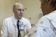 In this photo taken Thursday, April 2, 2015, Dr. Thomas Whetzel, chief of plastic surgery, consults with Army veteran Lisa at the Sacramento Veterans Affairs Medical Center in Rancho Cordova, Calif.  The Sacramento hospital had the highest percentage of appointments delayed by at least a month among VA centers in California and ranked sixth-worst nationally out of 150 full-service VA hospitals.(AP Photo/Rich Pedroncelli)