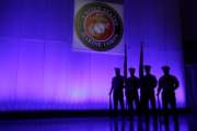 FILE- In this May 5, 2014, file photo, a U.S. Marine Corps Color Guard stands under a Marine Corps emblem in Jupiter, Fla. The Defense Department is investigating reports that some Marines shared naked photographs of female Marines, veterans and other women on a secret Facebook page, some of which were taken without their knowledge. Marine Corps Commandant Gen. Robert B. Neller on Sunday, March 5, 2017, called the online activity "distasteful" and says it shows an "absence of respect." (AP Photo/Wilfredo Lee, File)