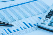 Accounting financial papers analysis charts with calculator, paper and pen in blue