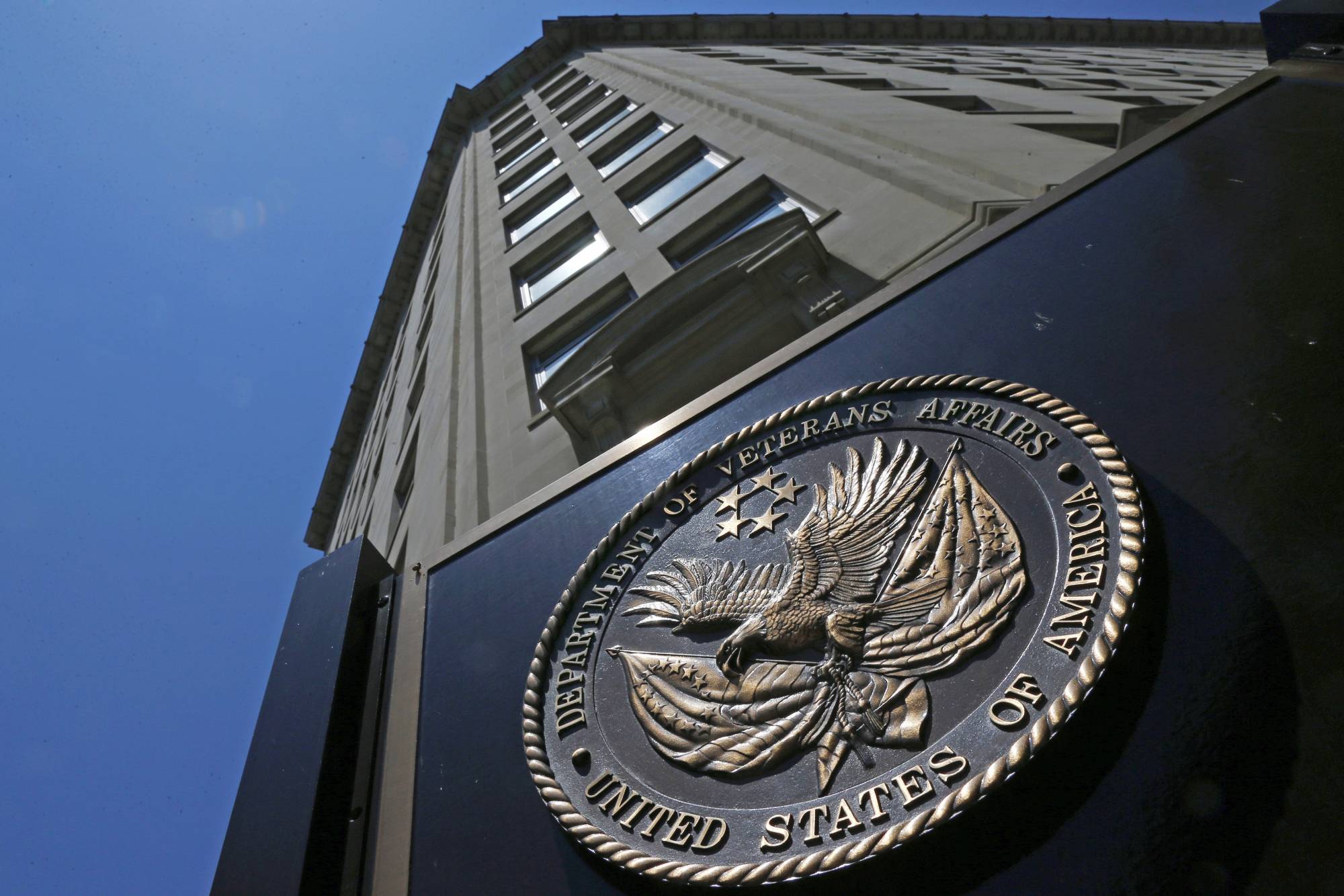 FILE - In this June 21, 2013, file photo, the seal a fixed to the front of the Department of Veterans Affairs building in Washington. The Republican-led House on March 16, 2017, has approved legislation to make it easier for the Department of Veterans Affairs to fire, suspend or demote employees for poor performance or bad conduct, part of a renewed effort targeting VA accountability in the new Trump administration. (AP Photo/Charles Dharapak, File)