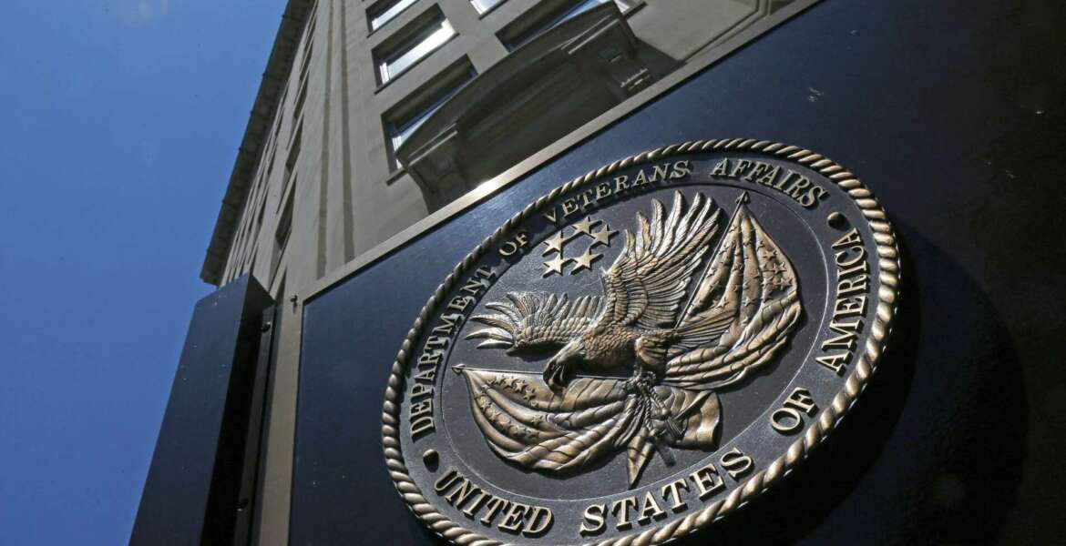 FILE - In this June 21, 2013, file photo, the seal affixed to the front of the Department of Veterans Affairs building in Washington. The Department of Veterans Affairs is warning of a rapidly growing backlog for veterans who seek to appeal decisions involving disability benefits, saying it will need much more staff even as money remains in question due to a tightening Trump administration budget.  (AP Photo/Charles Dharapak, File)