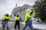 Workmen clear snow on Capitol Hill in Washington, Tuesday, March, 14, 2017. A late-season storm is dumping a messy mix of snow, sleet and rain on the mid-Atlantic, complicating travel, knocking out power and closing schools and government offices around the region.  (AP Photo/J. Scott Applewhite)