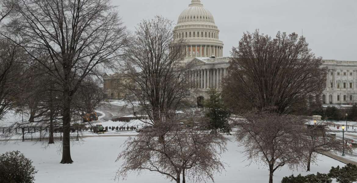 Snow covers Capitol Hill in Washington, early Tuesday, March, 14, 2017. A late-season storm is dumping a messy mix of snow, sleet and rain on the mid-Atlantic, complicating travel, knocking out power and closing schools and government offices around the region. (AP Photo/J. Scott Applewhite)