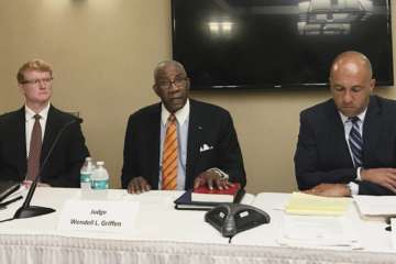 Pulaski County Circuit Judge Wendell Griffen, center, speaks at a news conference Wednesday, April 26, 2017, with his attorneys about a letter he's sent to two panels seeking an investigation into Arkansas' attorney general and Supreme Court over his removal from hearing death penalty cases. Griffen was removed from the cases after he participated in an anti-death penalty demonstration the same day he blocked Arkansas from using a lethal injection drug. (AP Photo/Andrew DeMillo)